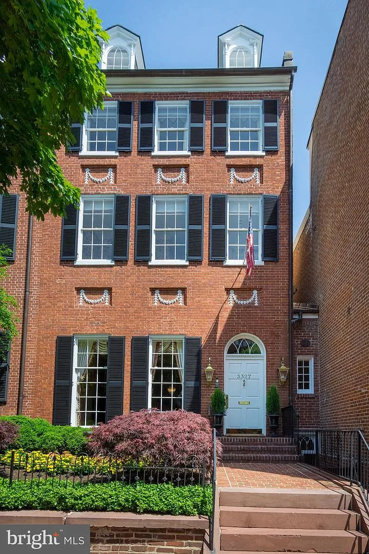 Historic brick townhouse with elegant entrance.