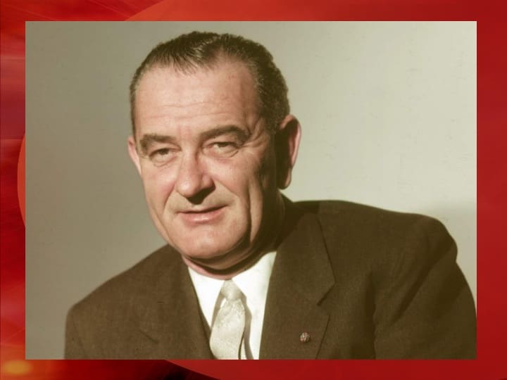 Man in suit with a red background.