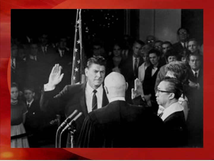 Man taking oath in front of audience.