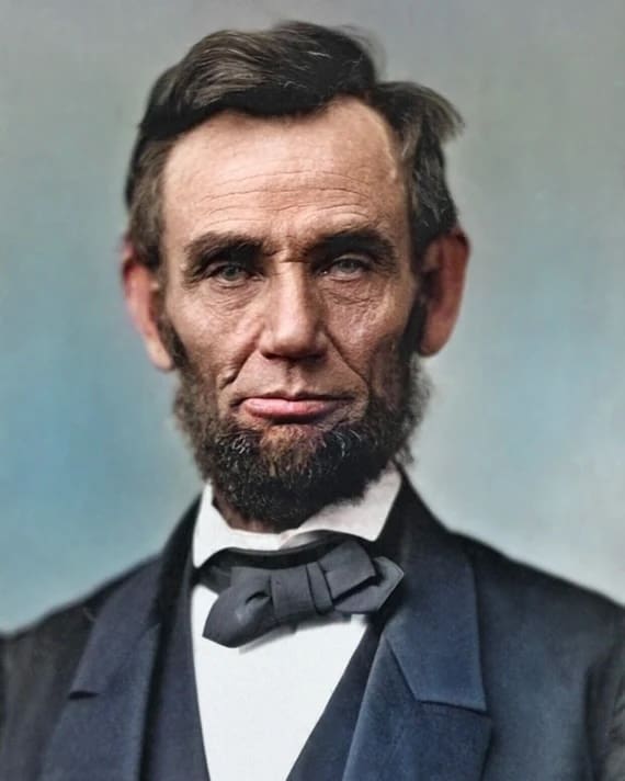 Man with a beard in formal attire.
