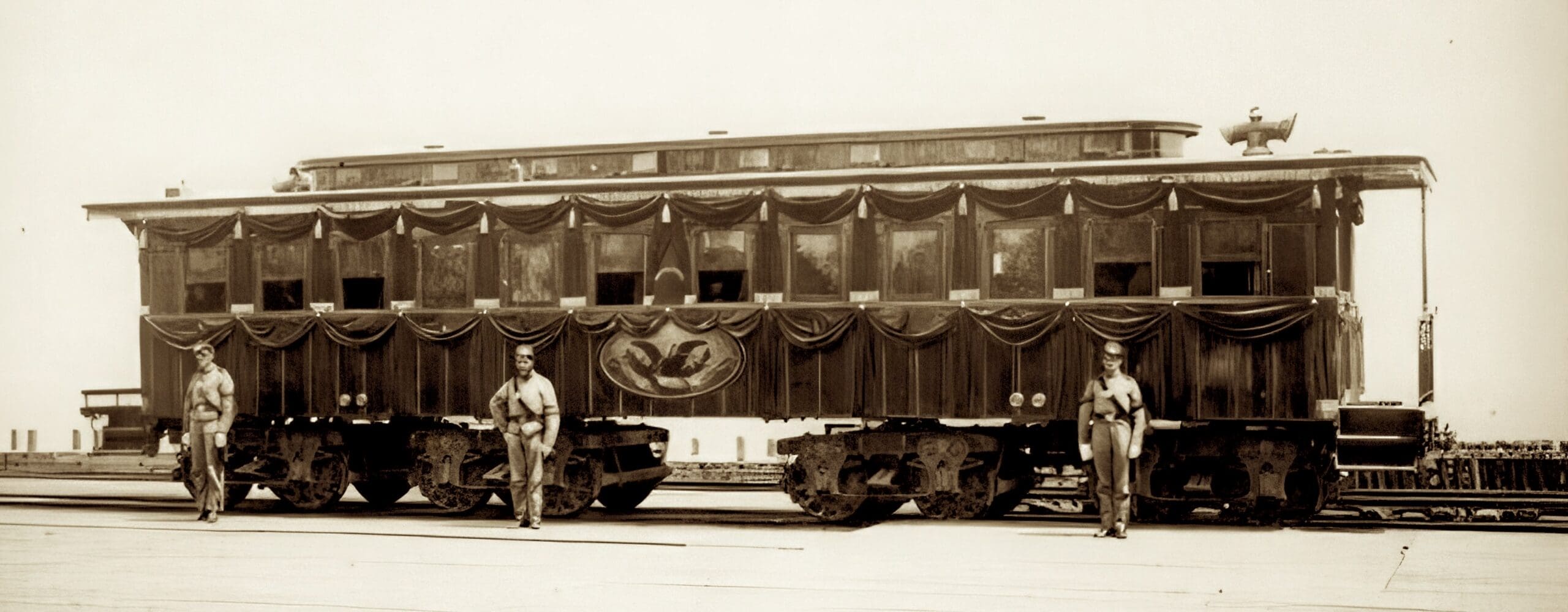 Vintage train car with ornate decorations, guards.